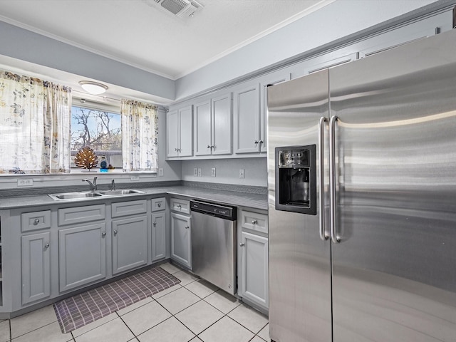 kitchen featuring crown molding, gray cabinets, visible vents, appliances with stainless steel finishes, and a sink