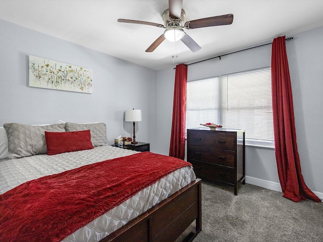 carpeted bedroom with ceiling fan and baseboards