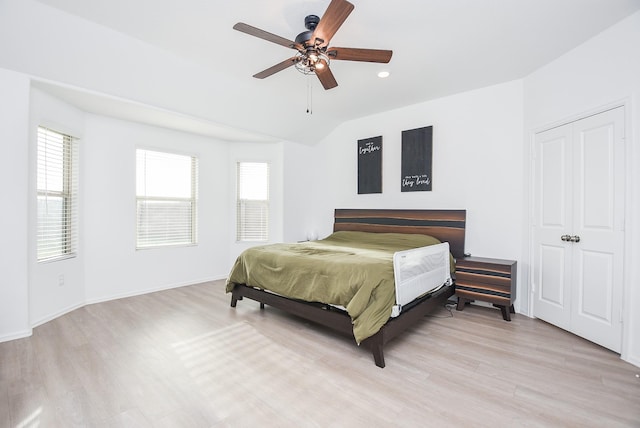 bedroom featuring ceiling fan, vaulted ceiling, and light wood-type flooring