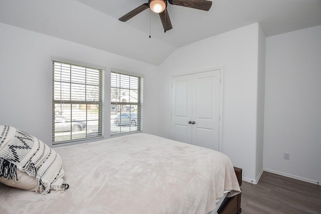 bedroom with lofted ceiling, dark hardwood / wood-style flooring, and ceiling fan