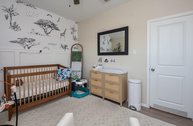 bedroom featuring a nursery area