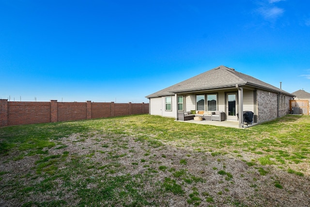 rear view of property with outdoor lounge area, a patio area, and a lawn