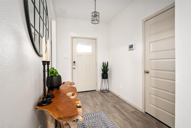 foyer featuring light wood-style flooring and baseboards