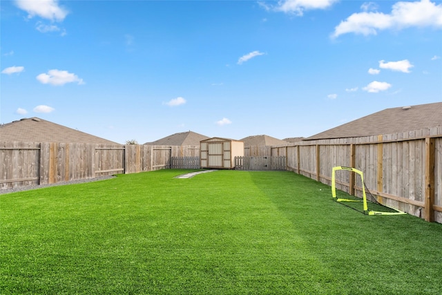 view of yard with a storage unit, an outdoor structure, and a fenced backyard