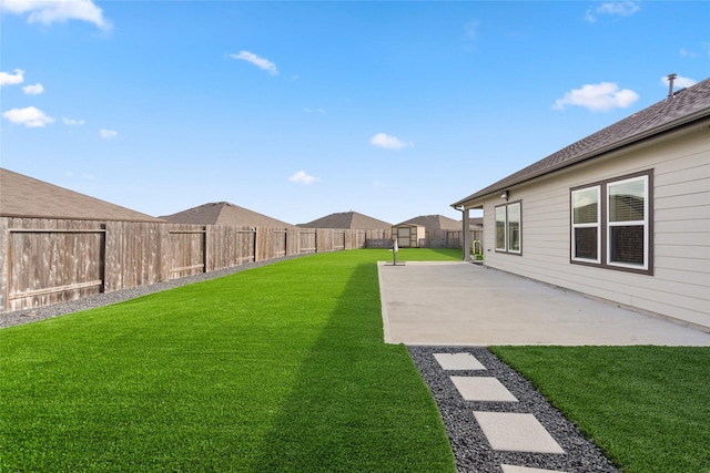 view of yard with a patio area and a fenced backyard