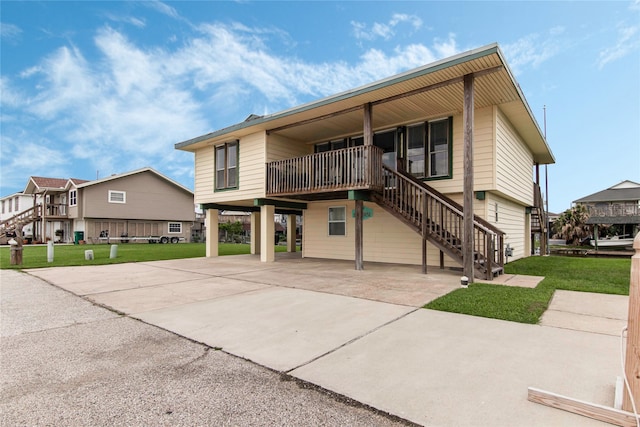 view of front of property with a carport and a front lawn