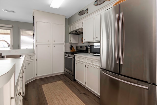 kitchen featuring white cabinetry, appliances with stainless steel finishes, sink, and dark wood-type flooring