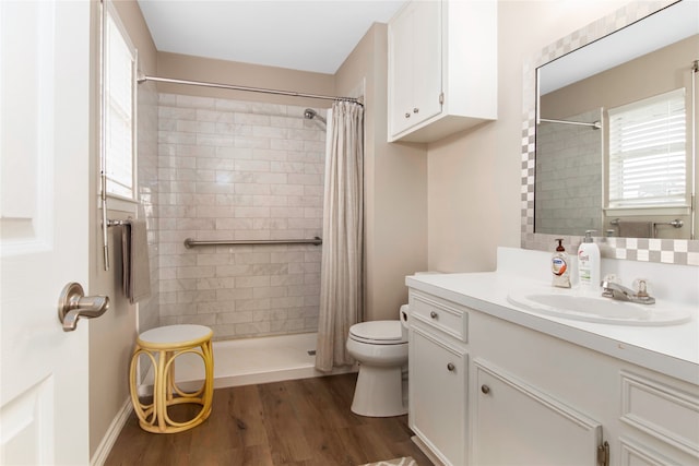 bathroom featuring hardwood / wood-style flooring, vanity, toilet, and walk in shower