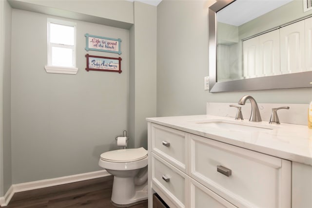 bathroom with vanity, hardwood / wood-style floors, and toilet