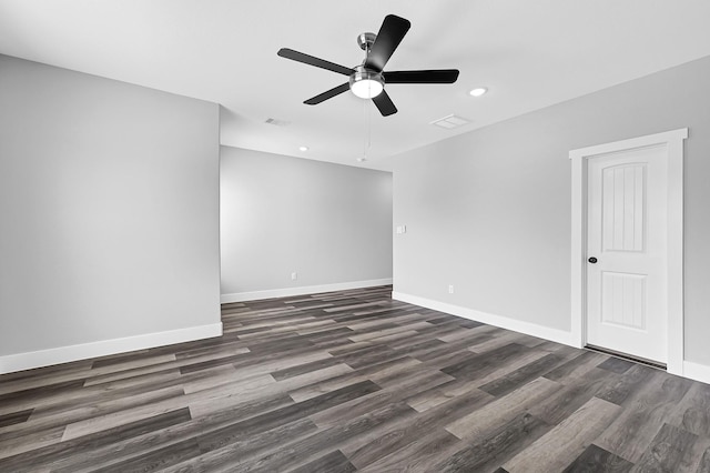 spare room with dark hardwood / wood-style flooring and ceiling fan