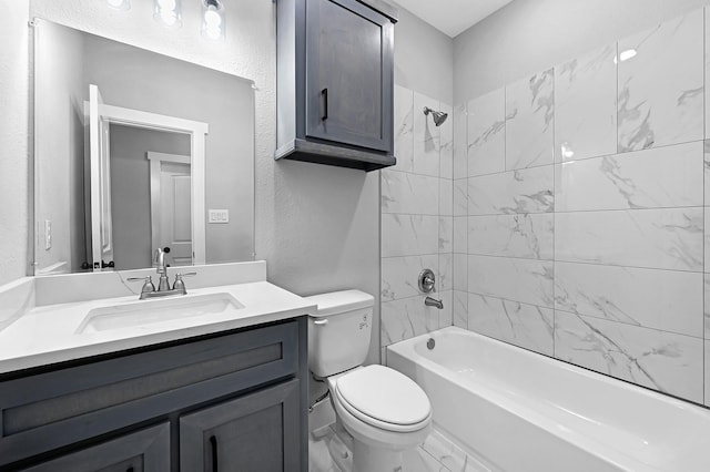 full bathroom featuring vanity, toilet, and tiled shower / bath combo