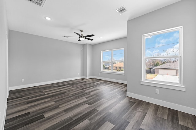 empty room featuring ceiling fan and dark hardwood / wood-style flooring