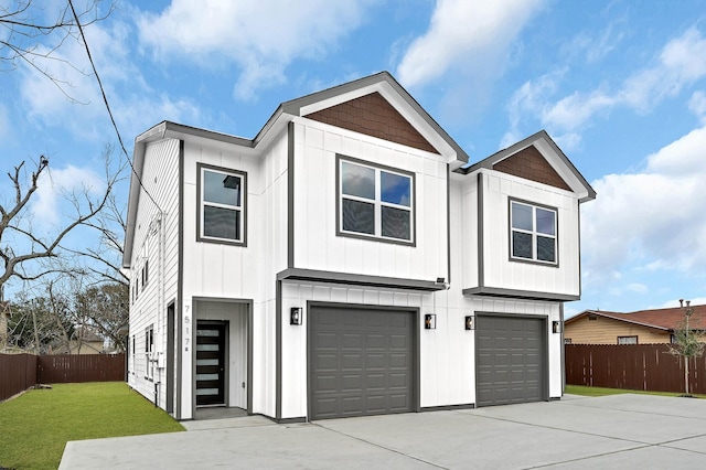 view of front of property with a garage and a front lawn