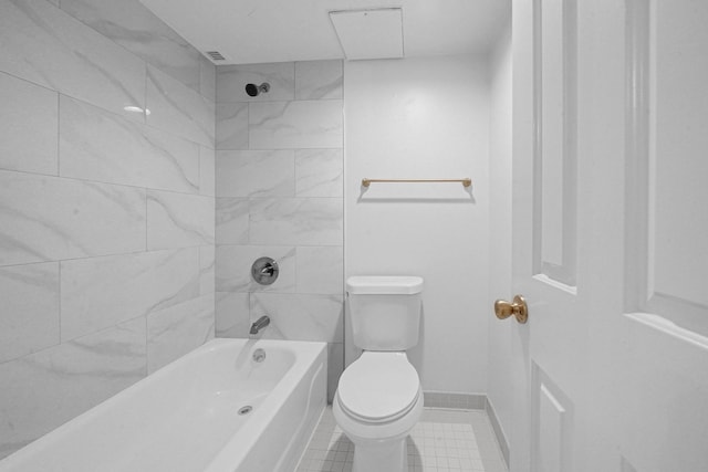 bathroom with tiled shower / bath combo and toilet