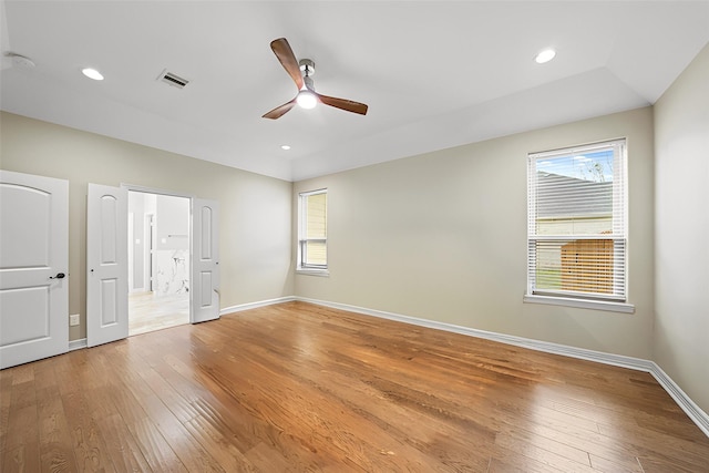 unfurnished bedroom featuring light wood finished floors, baseboards, multiple windows, recessed lighting, and a ceiling fan