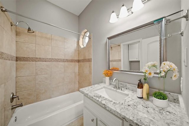 bathroom with vanity and tiled shower / bath combo