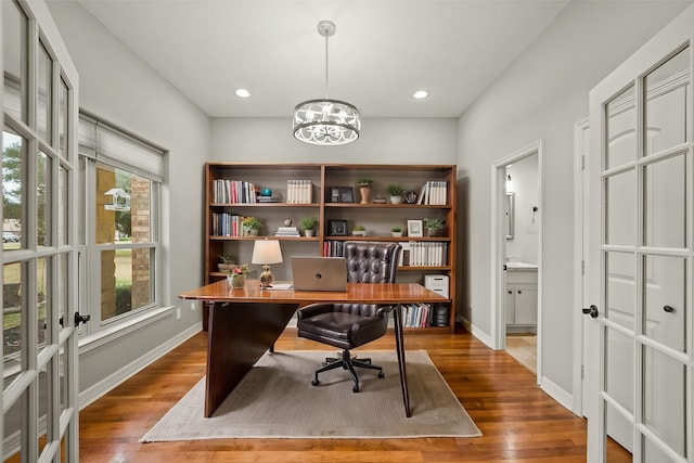 office space with wood finished floors, a chandelier, baseboards, and recessed lighting