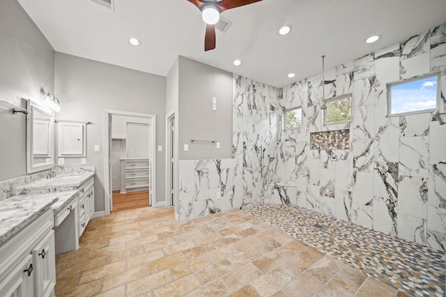 full bathroom with ceiling fan, a marble finish shower, vanity, recessed lighting, and stone tile flooring