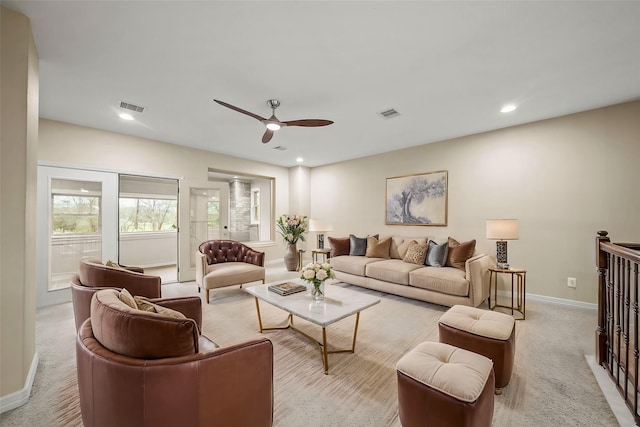 carpeted living room with ceiling fan