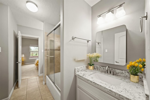 full bath with vanity, baseboards, tile patterned floors, and enclosed tub / shower combo