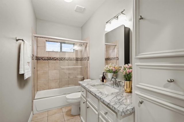 full bathroom featuring tile patterned flooring, vanity, bath / shower combo with glass door, and toilet