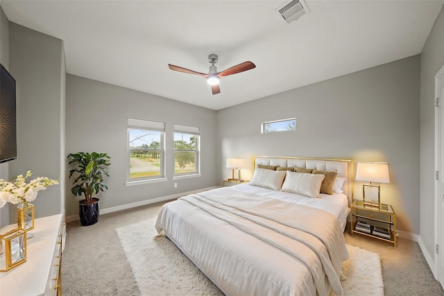 carpeted bedroom featuring baseboards and a ceiling fan