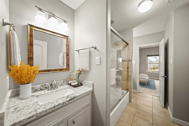 bathroom with vanity, a textured ceiling, tile patterned floors, and shower / bath combination with glass door