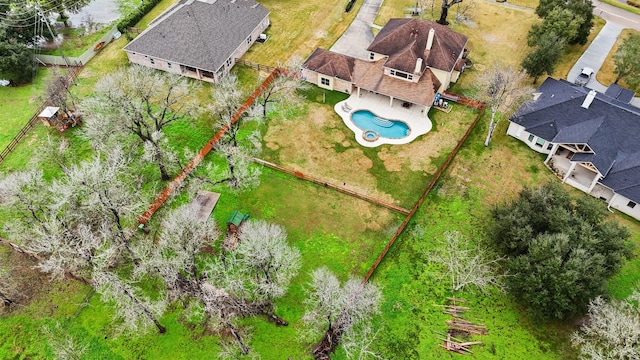 aerial view of property and surrounding area with a pool area