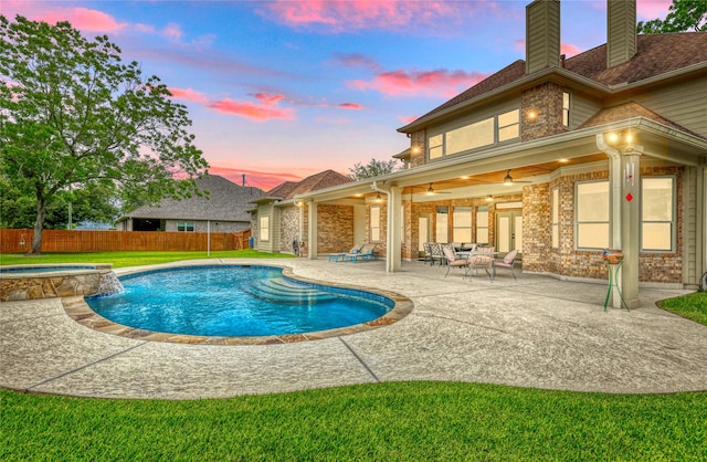 32603 Westminster Dr, Fulshear, TX 77441 - pool at dusk with a fenced backyard, a patio, a ceiling fan, and a pool with connected hot tub