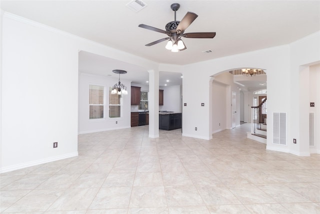 unfurnished living room featuring crown molding and ceiling fan with notable chandelier