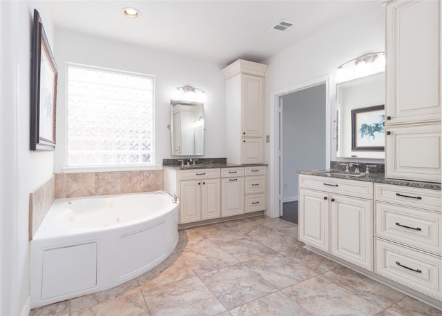 bathroom with vanity and a bathing tub