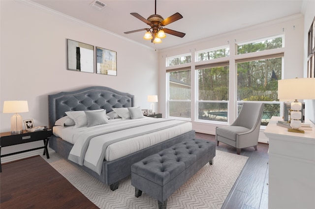 bedroom with ceiling fan, ornamental molding, and hardwood / wood-style floors