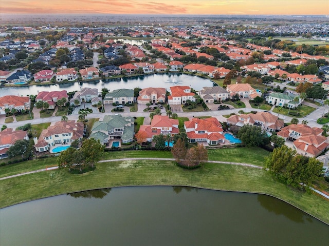 aerial view at dusk with a water view