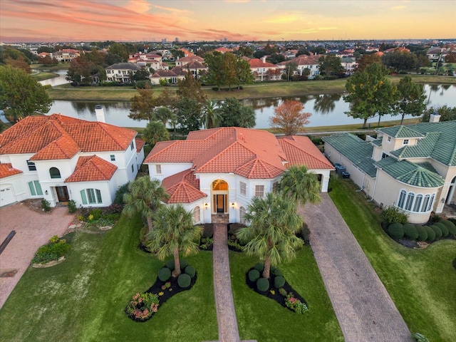 aerial view at dusk with a water view