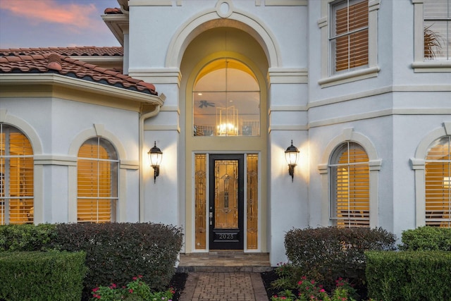 view of exterior entry at dusk