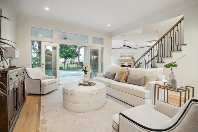 living room with ornamental molding and light wood-type flooring