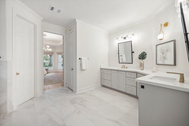 bathroom with crown molding, vanity, and a chandelier