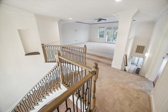 hallway with crown molding, carpet, and french doors