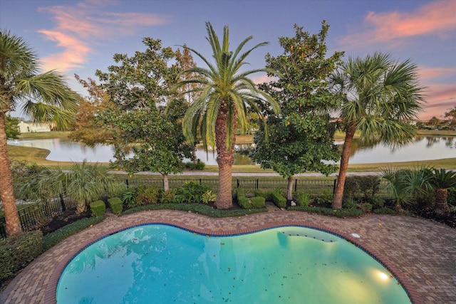 pool at dusk with a water view