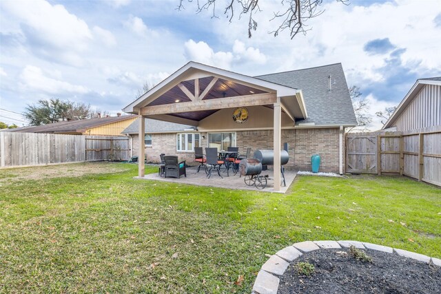 back of house featuring a yard and a patio area