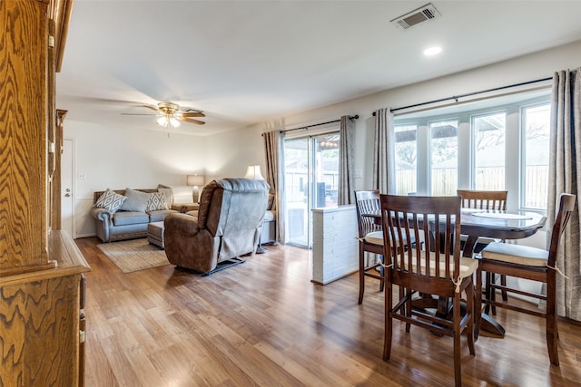 dining space with ceiling fan and light hardwood / wood-style floors