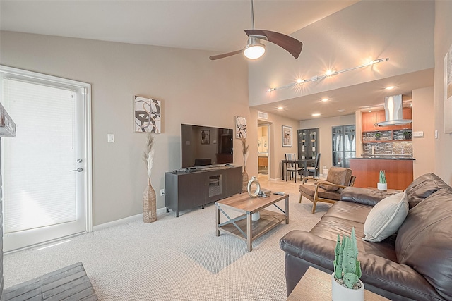 carpeted living room with ceiling fan and lofted ceiling