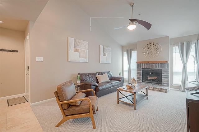 living room featuring lofted ceiling, a fireplace, tile patterned floors, and ceiling fan