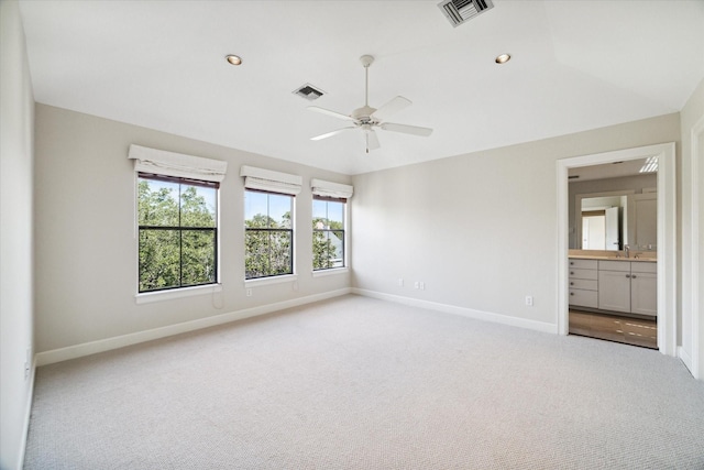 carpeted empty room with lofted ceiling, sink, and ceiling fan