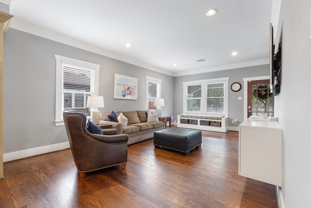 living room featuring dark wood-type flooring and ornamental molding