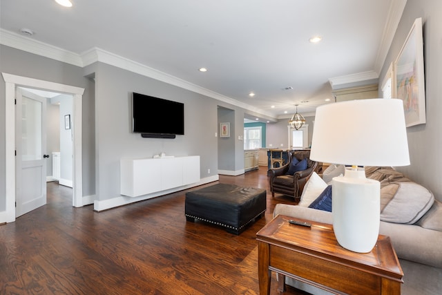 living room featuring ornamental molding, hardwood / wood-style floors, and a chandelier