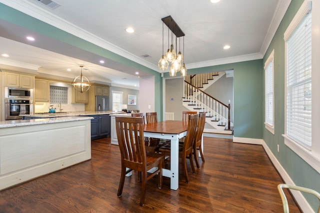 dining area with crown molding, dark hardwood / wood-style flooring, and an inviting chandelier