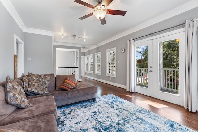 living room featuring crown molding, plenty of natural light, dark hardwood / wood-style flooring, and french doors