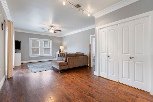 living room with dark hardwood / wood-style flooring, track lighting, ornamental molding, and ceiling fan