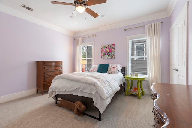 bedroom with ceiling fan, light colored carpet, and ornamental molding